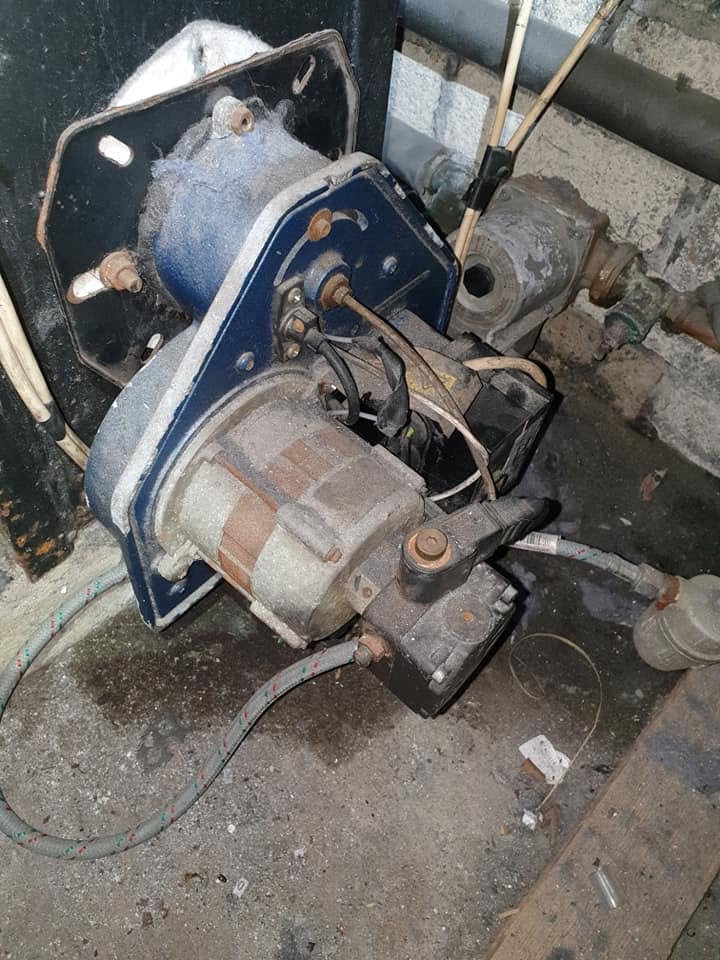 An oil burner being inspected during service work